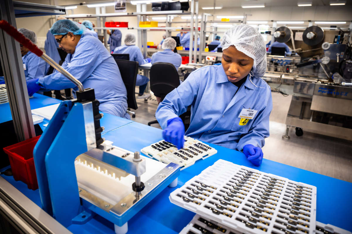 Employees work on the production line of a COVID-19 home test unit that has been granted an Emergency Use Authorization by the U.S. Food and Drug Administration, at the production facility of Australian digital diagnostics company Ellume in Brisbane, December 21, 2020.