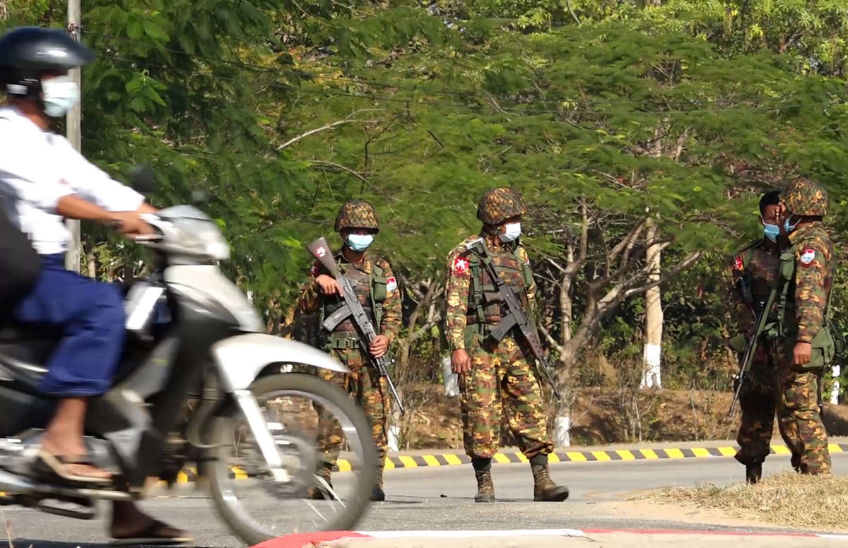 Soldiers stand guard on a street in Naypyidaw on February 1, 2021, after the military detained the country's de facto leader Aung San Suu Kyi in a coup.