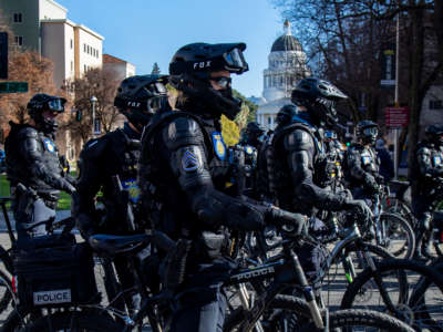 Sacramento Police officers in riot gear on bikes stay close to Antifa protesters marching near the California State Capitol on January 20, 2021, in Sacramento, California.