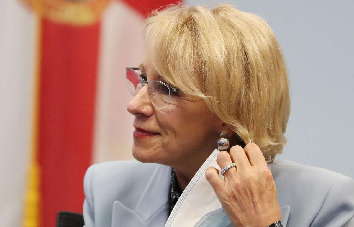 Secretary of Education Betsy DeVos dons a mask during a visit to Florida Virtual School in Orlando, Florida, on October 26, 2020.