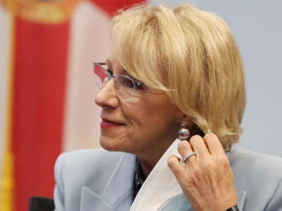 Secretary of Education Betsy DeVos dons a mask during a visit to Florida Virtual School in Orlando, Florida, on October 26, 2020.