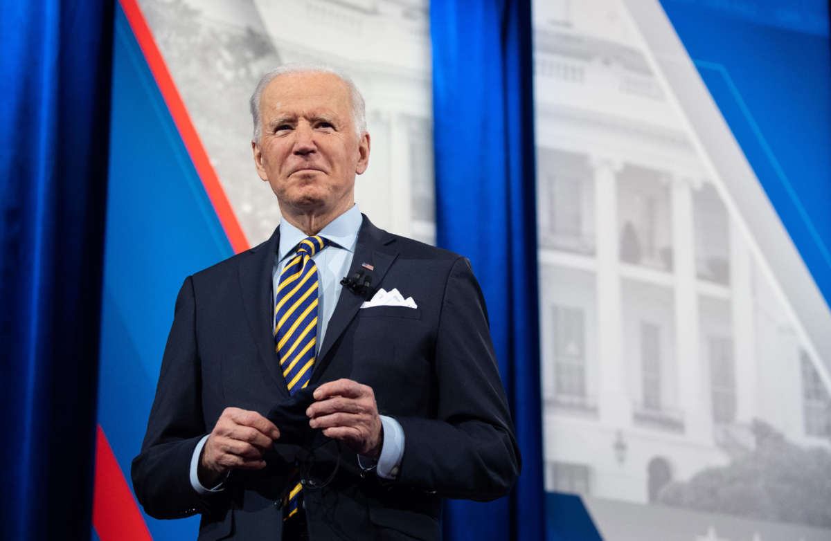 President Biden holds a face mask as he participates in a CNN town hall at the Pabst Theater in Milwaukee, Wisconsin, February 16, 2021.