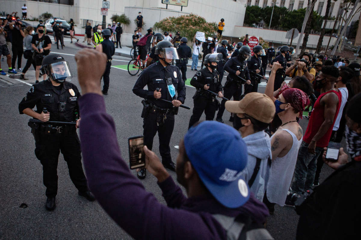 Black Lives Matters protesters stand united as they confront LAPD, protesting the killing of George Floyd in Minnesota by police on May 27, 2020, in Los Angeles, California.