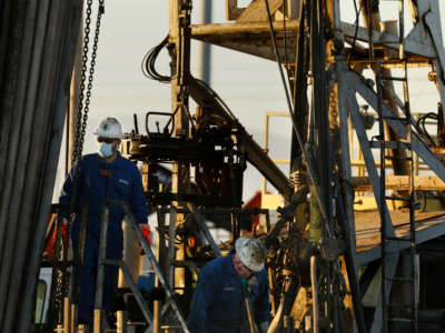 In the Midway-Sunset Oil Field outside Taft, California, men work on a well abandonment, which is a process that renders an oil well closed for good, on April 29, 2020.