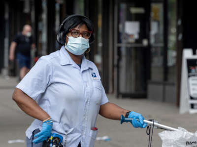 A USPS mail worker is seen on August 06, 2020, in New York City.