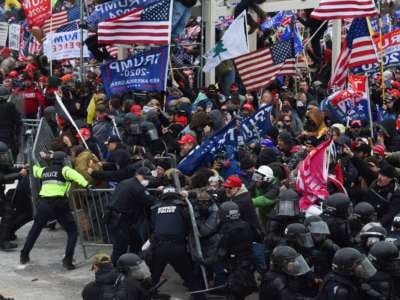 Trump loyalists clash with police and security forces as they push barricades to storm the U.S. Capitol in Washington, D.C., on January 6, 2021.