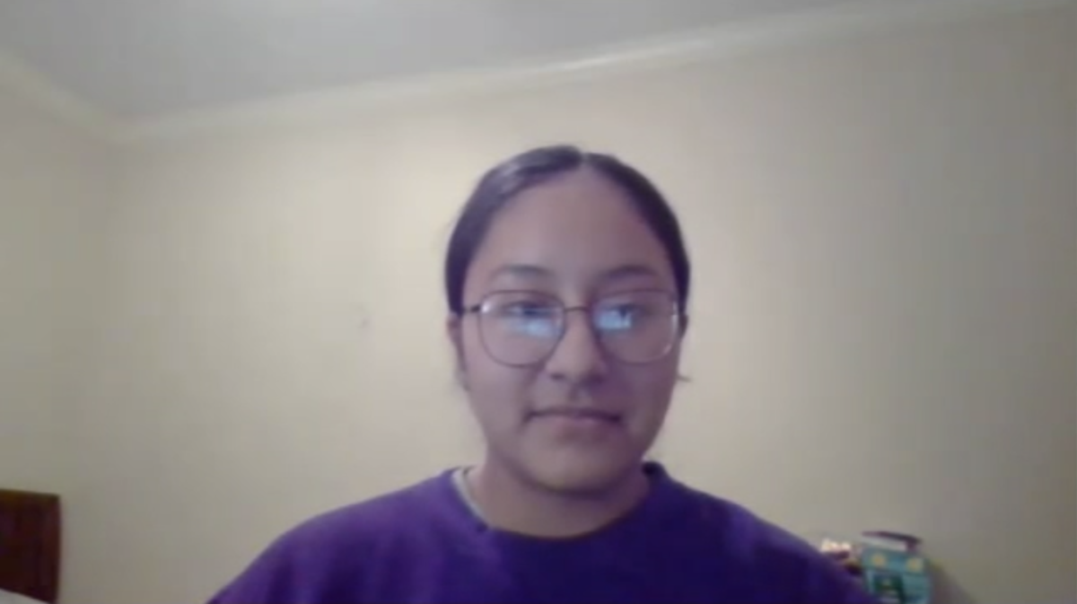 A young woman in glasses and a purple shirt