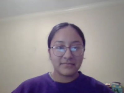 A young woman in glasses and a purple shirt