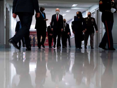 President Joe Biden, center, accompanied by Vice President Kamala Harris, right center, Secretary of Defense Lloyd Austin, left, and Joint Chiefs Chairman Gen. Mark Milley, right, tours the Pentagon on February 10, 2021, in Washington, D.C.