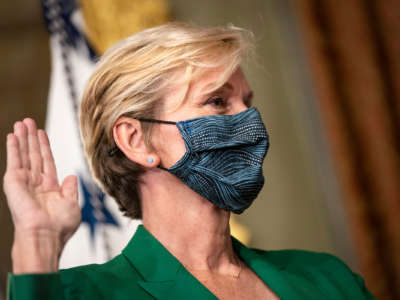 Jennifer Granholm raises her right hand to sear an oath