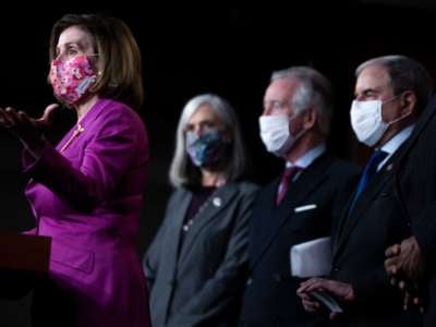 Nacy Pelosi speaks at a podium