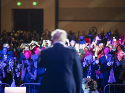 The back of Donald Trump's head is seen as he speaks to a crowd of supporters