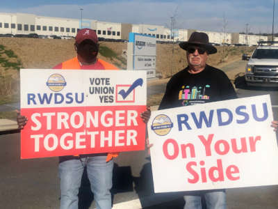 Retail, Wholesale and Department Store Union (RWDSU) organizers stand outside the entrance to Amazon's warehouse in Bessemer, Alabama on March 10, 2020. 