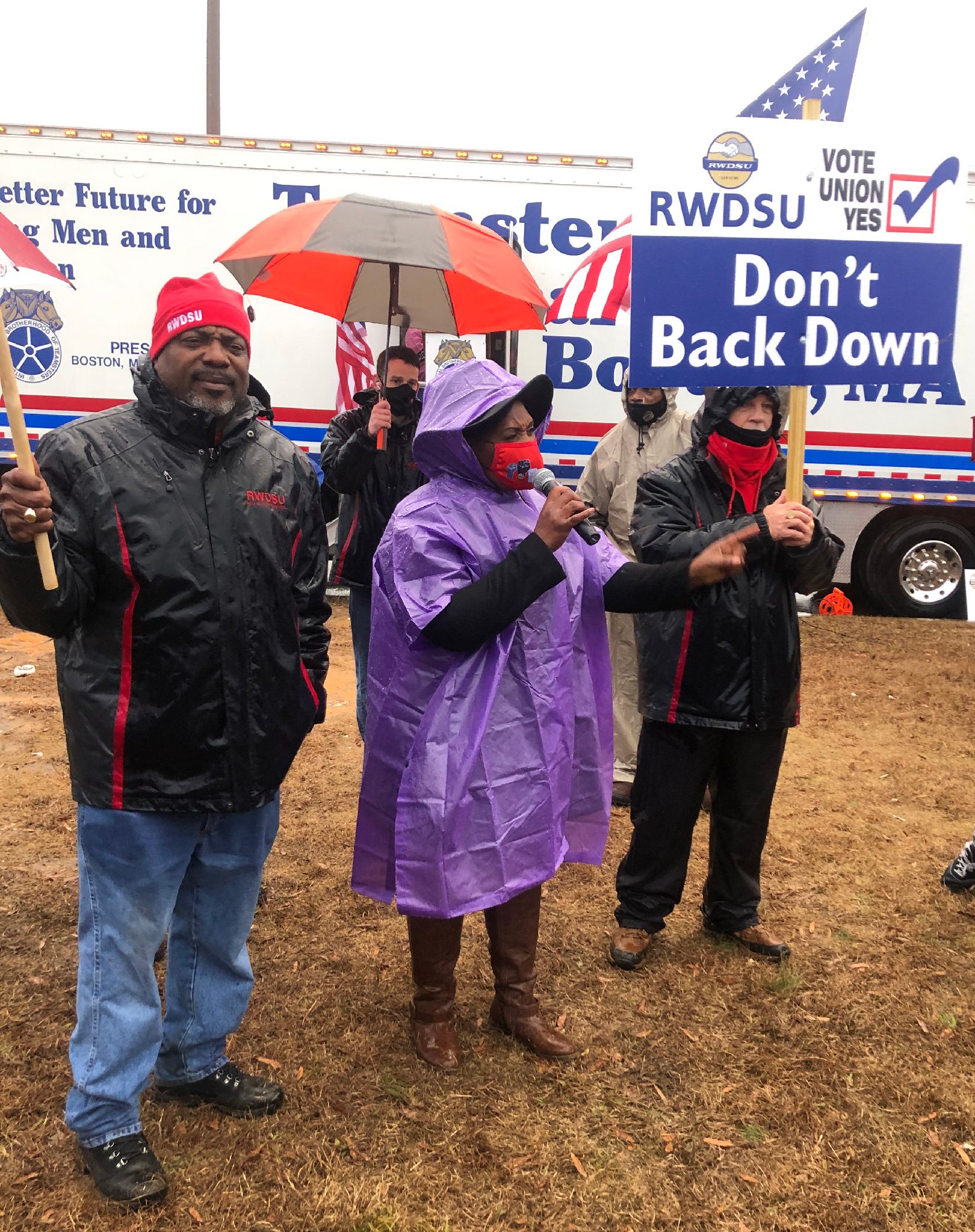 Amazon worker Jennifer Bates wearing a purple poncho speaks in the rain at a rally in Bessemer, Alabama on February 6, 2021. 