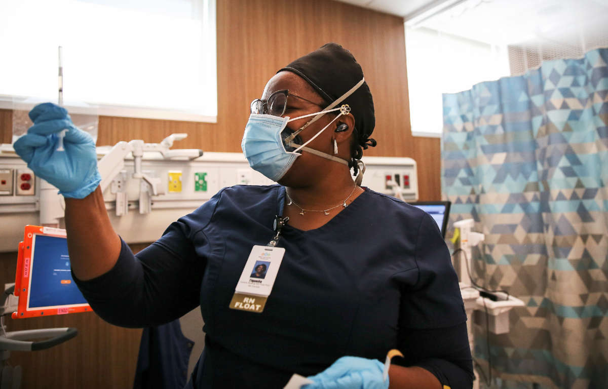 Travel nurse Tiquella Russell of Texas prepares to administer a dose of the COVID-19 vaccine at a clinic at Martin Luther King Jr. Community Hospital on February 25, 2021, in Los Angeles, California.