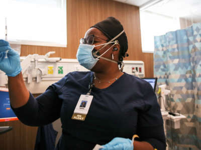 Travel nurse Tiquella Russell of Texas prepares to administer a dose of the COVID-19 vaccine at a clinic at Martin Luther King Jr. Community Hospital on February 25, 2021, in Los Angeles, California.