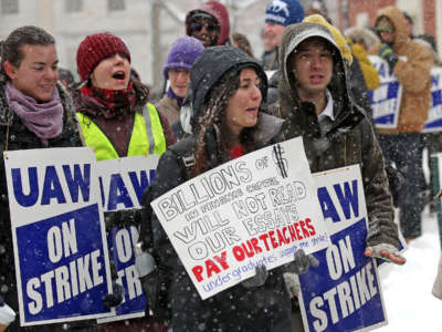 Students display signs and chant during an outdoor pre-covid protest