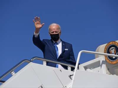 Joseph Robinette Biden waves to the press from the steps of Air Force One