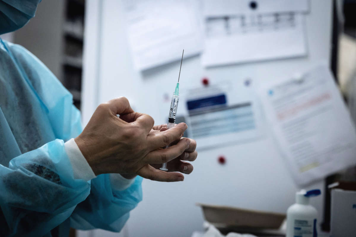 A medical worker handles a Covid-19 vaccine