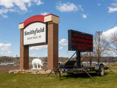 A sign outside the Smithfield Foods pork processing plant in South Dakota, one of the country's largest known Coronavirus clusters, is seen on April 21, 2020, in Sioux Falls, South Dakota.