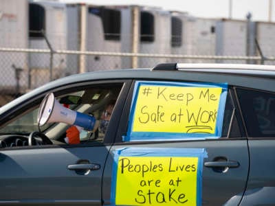 Patty Keeling, vice president of the Asamblea de Derechos Civiles, led chants with a megaphone from inside her car parked outside the Pilgrim's Pride plant Monday afternoon.