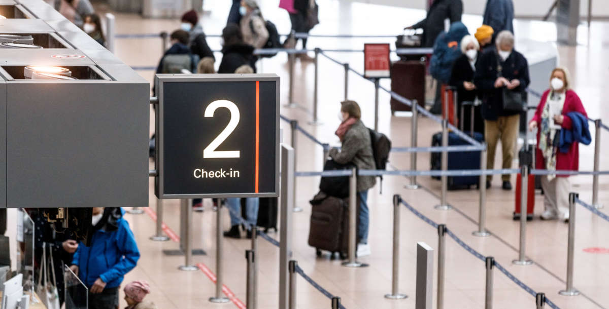 Passengers check in at Hamburg Airport in Germany, on March 14, 2021.