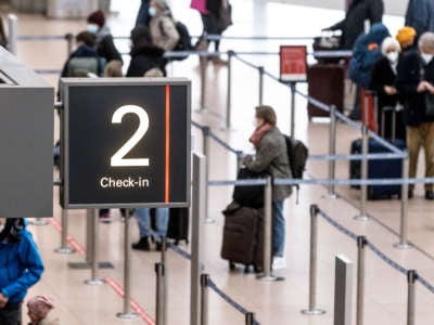 Passengers check in at Hamburg Airport in Germany, on March 14, 2021.