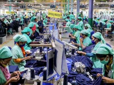 Garment employees work in a sewing section of a Textile Mills Limited in Gazipur, Bangladesh, on March 18, 2021.