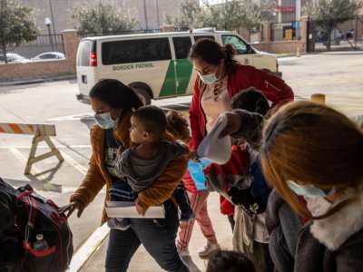 A family of Central American asylum seekers arrives to a bus station after being dropped off by U.S. Border Patrol agents on February 25, 2021, in Brownsville, Texas.