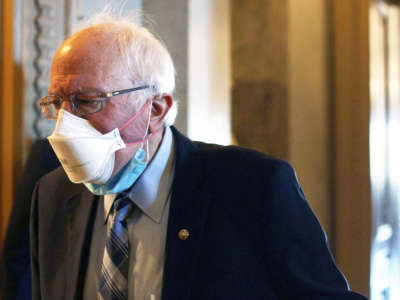 Sen. Bernie Sanders passes through a hallway at the U.S. Capitol March 5, 2021, in Washington, D.C.