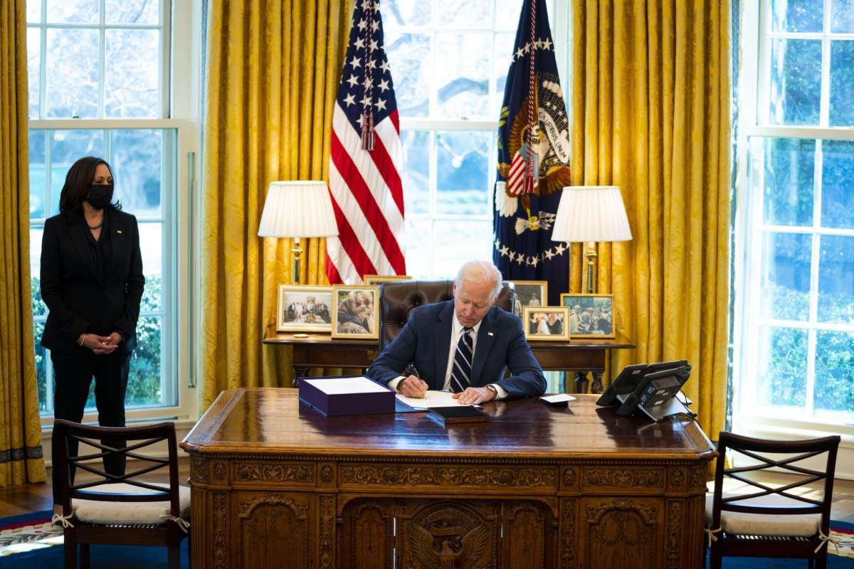 President Joe Biden participates in a bill signing as Vice President Kamala Harris looks on in the Oval Office of the White House on March 11, 2021, in Washington, D.C.
