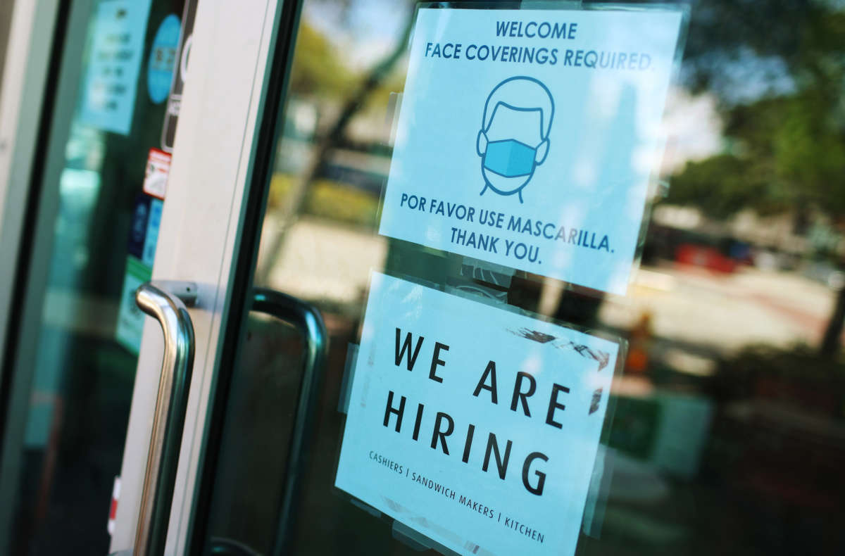 A "we are hiring" sign is seen in front of a store on March 5, 2021, in Miami, Florida.