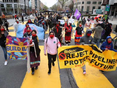 Indigenous environmental activists march through Black Lives Matter Plaza on their way to the White House as part of a protest against oil pipelines on April 1, 2021, in Washington, D.C.