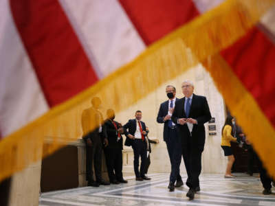 Senate Minority Leader Mitch McConnell and Sen. John Thune walk out of the weekly Senate Republican caucus luncheon in the Russell Senate Office Building on Capitol Hill on March 16, 2021, in Washington, D.C.