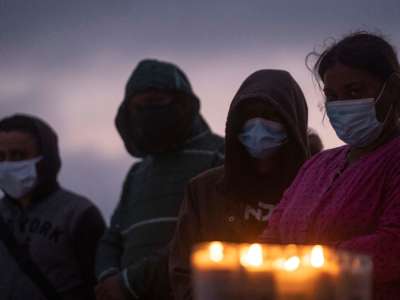 People mourn during a candlight vigil