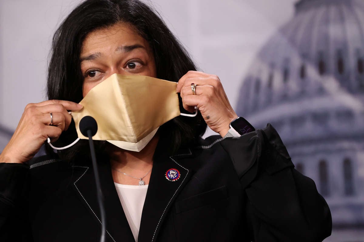 Rep. Pramila Jayapal puts on a mask