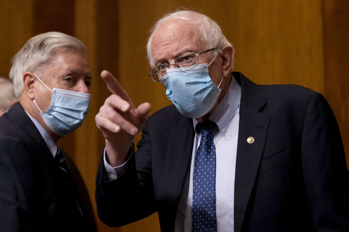Chairman Sen. Bernie Sanders (I-Vermont) right, greets Sen. Lindsey Graham, (R-South Carolina) left, before Neera Tanden testifies before a Senate Committee on the Budget hearing on Capitol Hill on February 10, 2021 in Washington, D.C.
