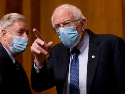 Chairman Sen. Bernie Sanders (I-Vermont) right, greets Sen. Lindsey Graham, (R-South Carolina) left, before Neera Tanden testifies before a Senate Committee on the Budget hearing on Capitol Hill on February 10, 2021 in Washington, D.C.