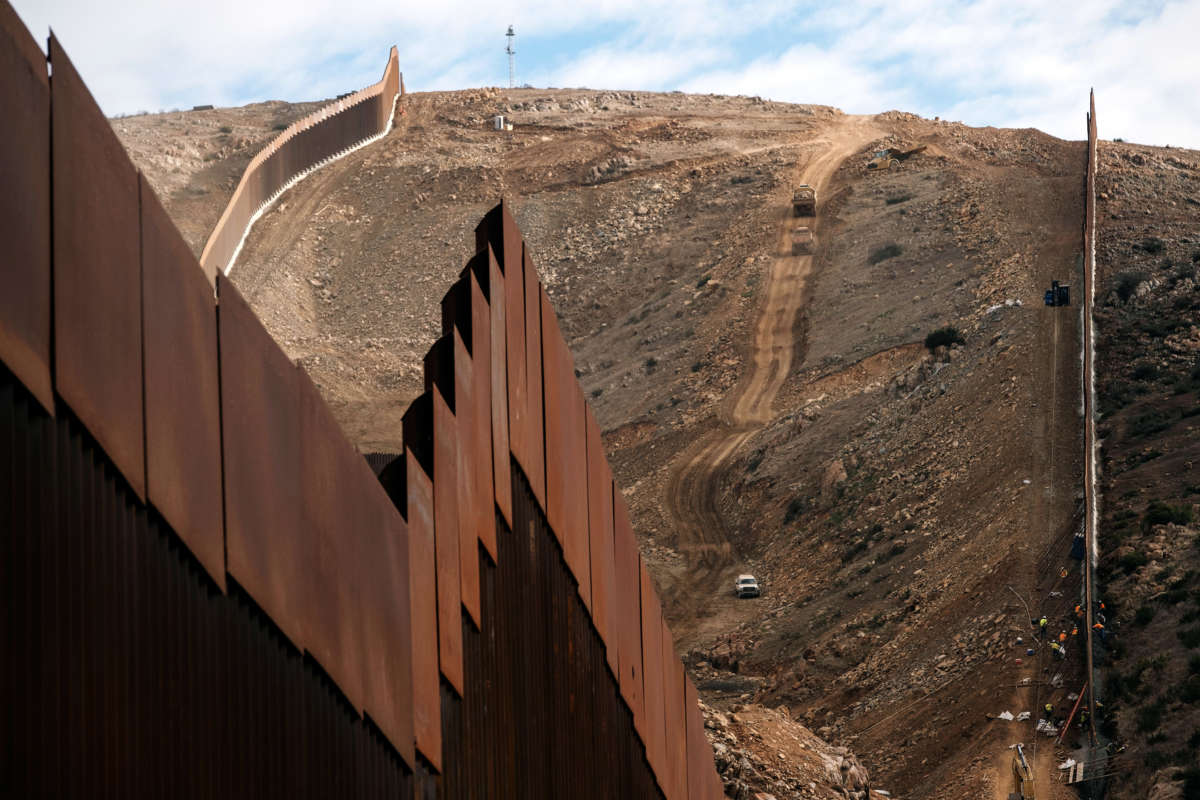 Construction crews work on a new section of the U.S.-Mexico border fencing at El Nido de Las Águilas, eastern Tijuana, Baja California State, Mexico, on January 20, 2021.