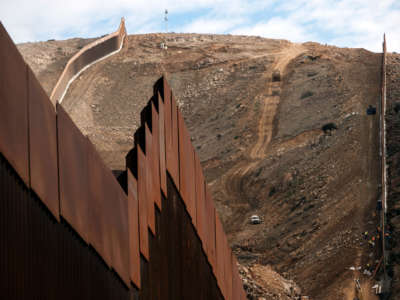 Construction crews work on a new section of the U.S.-Mexico border fencing at El Nido de Las Águilas, eastern Tijuana, Baja California State, Mexico, on January 20, 2021.