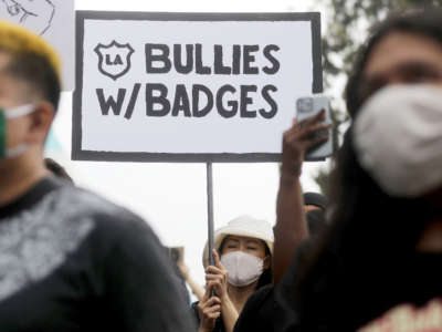 Protesters outside the Unified School District headquarters call on the board of education to defund school police on June 23, 2020, in Los Angeles, California.