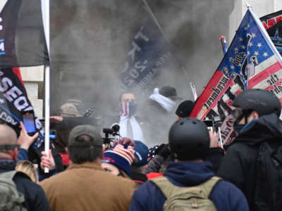 Trump supporters are seen through tear gas outside the U.S. Capitol in Washington, D.C., on January 6, 2021.