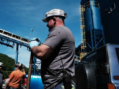 Men pause while working at a coal prep plant outside the city of Welch in rural West Virginia on May 19, 2017, in Welch, West Virginia.