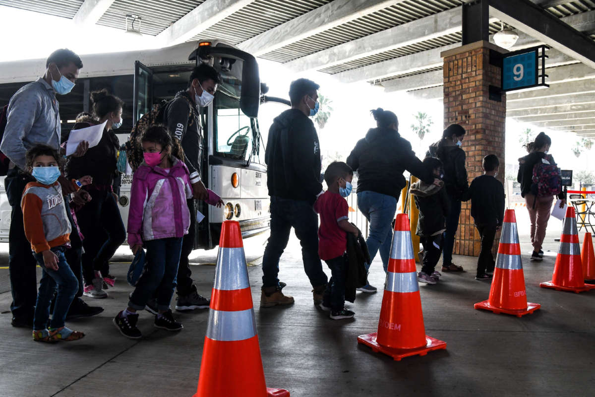 Migrants, mostly from Central America, are dropped off by the U.S. Customs and Border Protection at a bus station near the Gateway International Bridge, between the cities of Brownsville, Texas, and Matamoros, Mexico, on March 15, 2021.