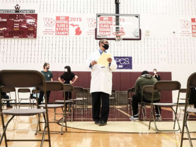 Medical staff watch and advise walk-in patients who received their COVID-19 vaccination at a pop-up clinic at Western International High School on April 12, 2021, in Detroit, Michigan.