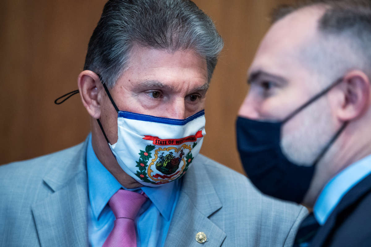 Sen. Joe Manchin and Tommy P. Beaudreau, nominee for deputy Interior secretary, talk before Beaudreau's Senate Energy and Natural Resources Committee confirmation hearing in the Dirksen Building on Thursday, April 29, 2021.