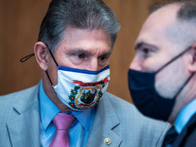 Sen. Joe Manchin and Tommy P. Beaudreau, nominee for deputy Interior secretary, talk before Beaudreau's Senate Energy and Natural Resources Committee confirmation hearing in the Dirksen Building on Thursday, April 29, 2021.