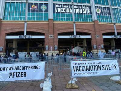 People line up at M&T Bank Stadium in Baltimore, Maryland, which was transformed into a COVID-19 mass vaccination site, on March 20, 2021.