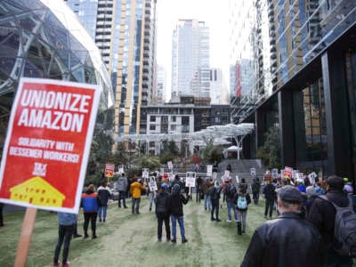 People hold pro-union signs during a rally at the Amazon Spheres and headquarters in solidarity with Amazon workers hoping to unionize in Bessemer, Alabama, in Seattle, Washington, on March 26, 2021.