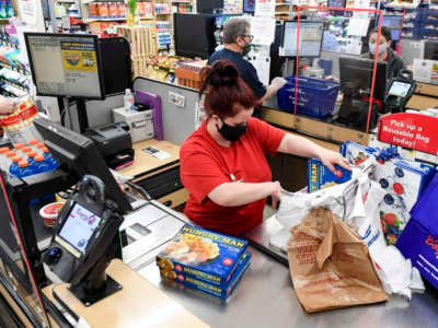 Boyer's cashier Kathryn Laudermilch bags a customers groceries at the Boyer's Food Markets grocery store in Womelsdorf, Pennsylvania, on April 8, 2021.